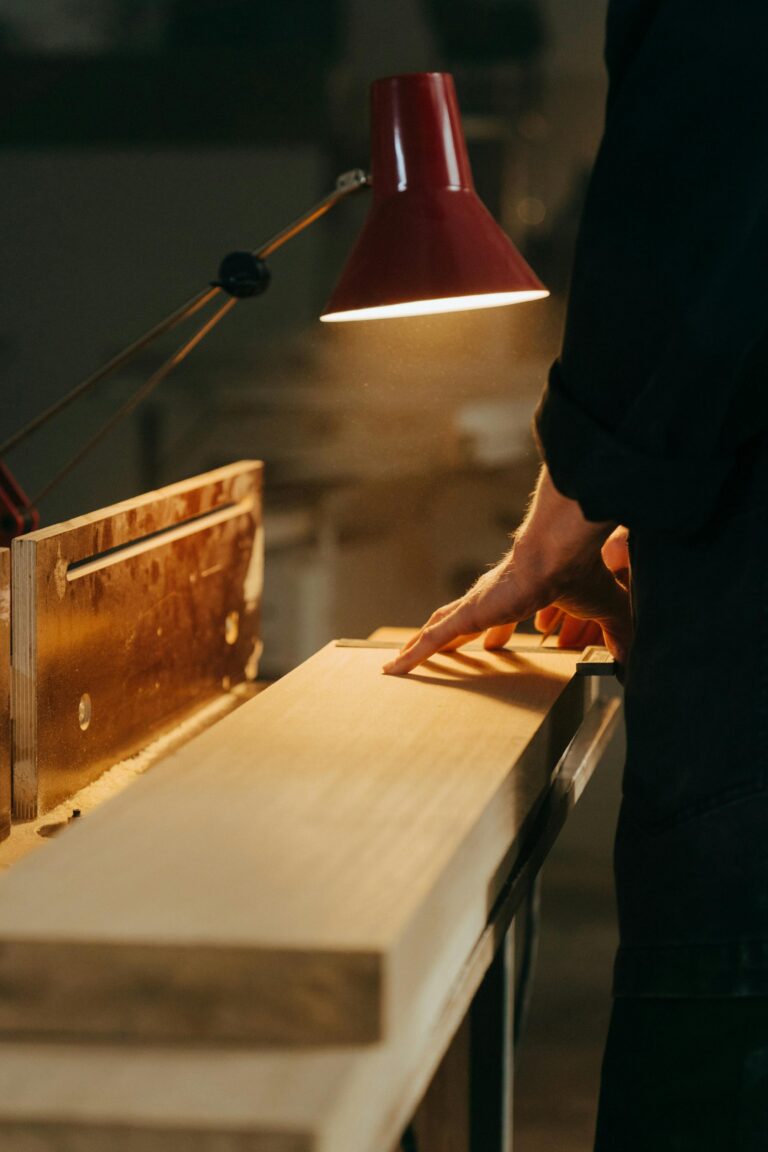A person running their hand over a carefully crafted piece of timber