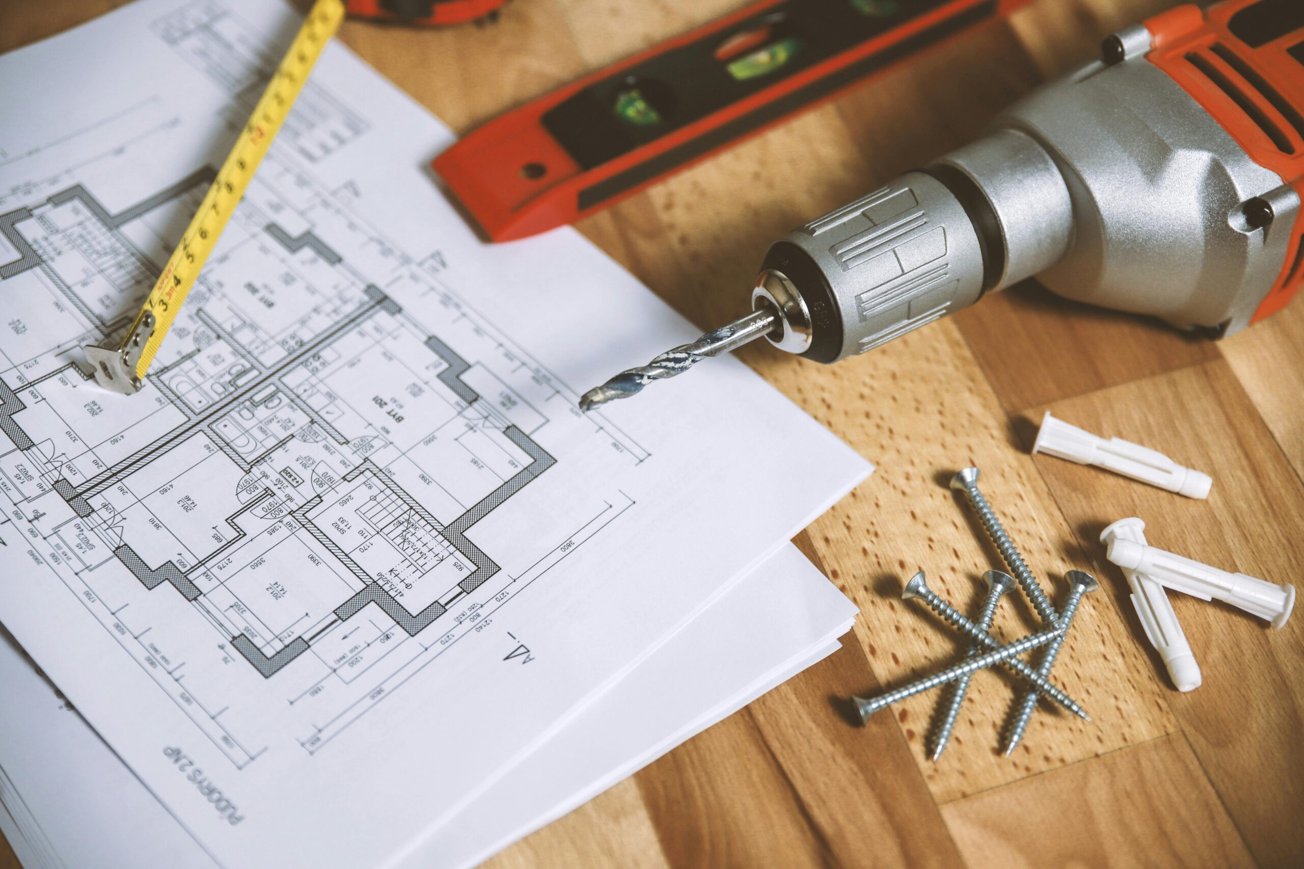 Building plans with tools on the top of them
