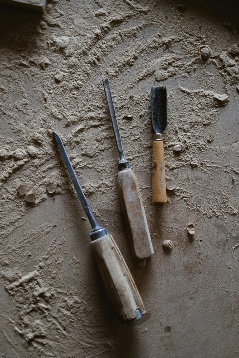 carpentry tools on the floor with woodchips and dust around them